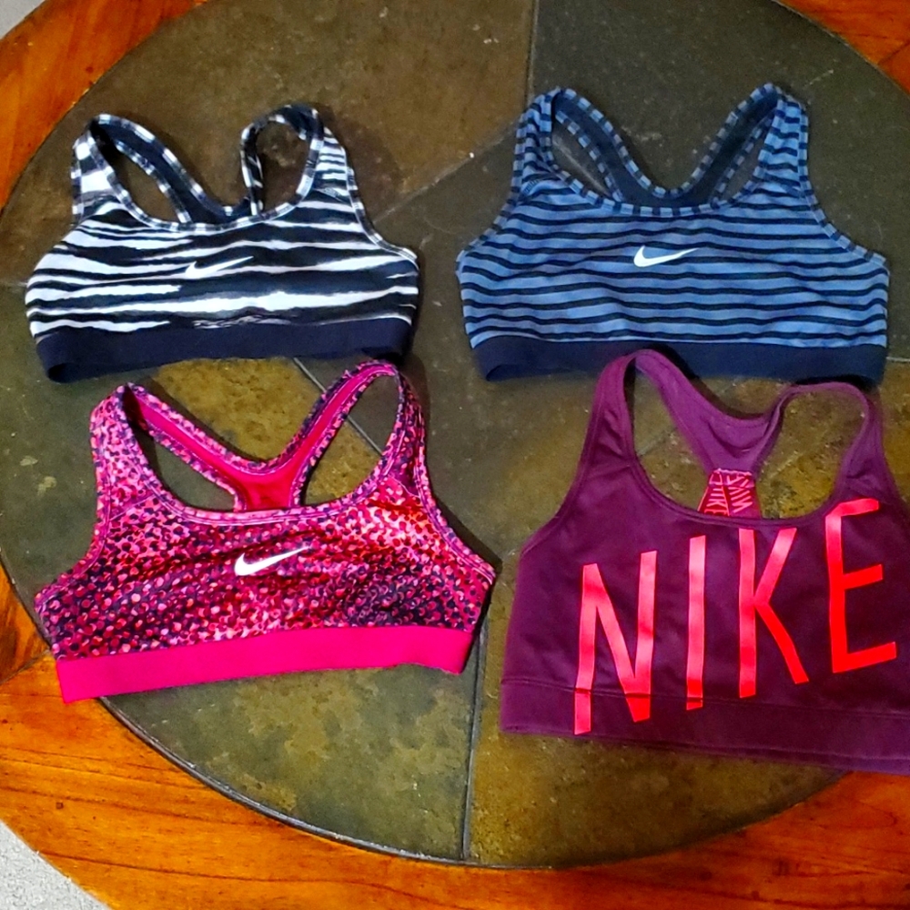 Set of (4) sports bras.  Gently used. (3) size medium.. (1) size xsmall